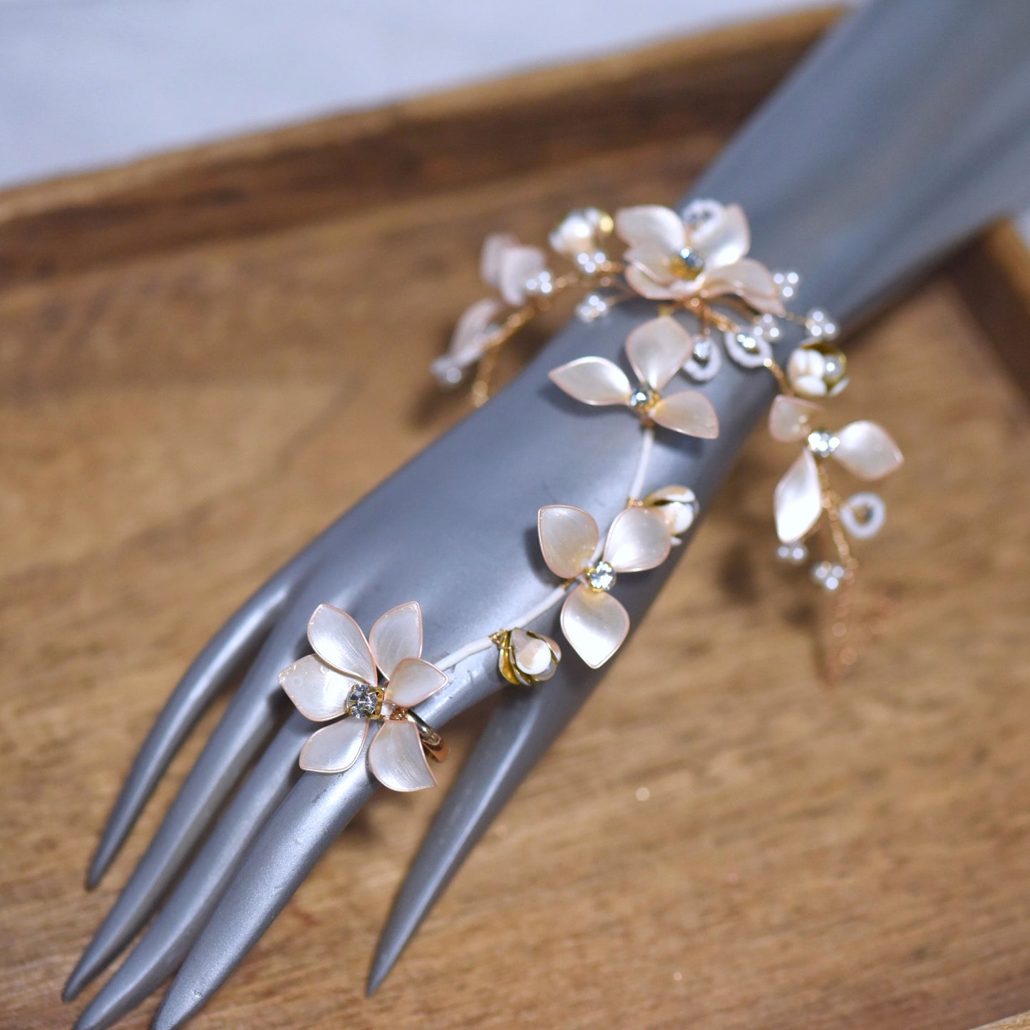 Amarille ivory resin floral haath phool with golden yellow accents worn from wrist to finger