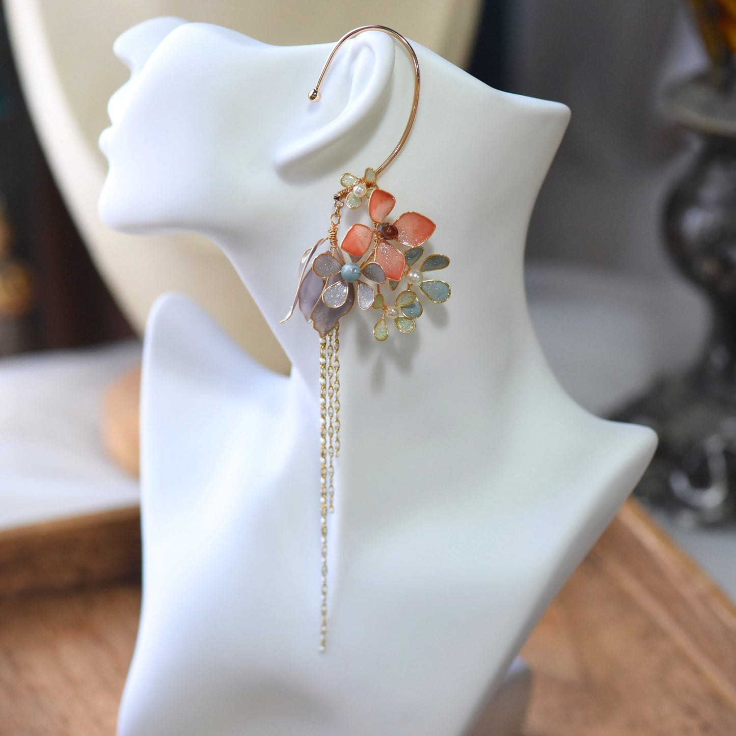 Althea Cascade pastel resin floral and pearl ear cuff displayed on white bust