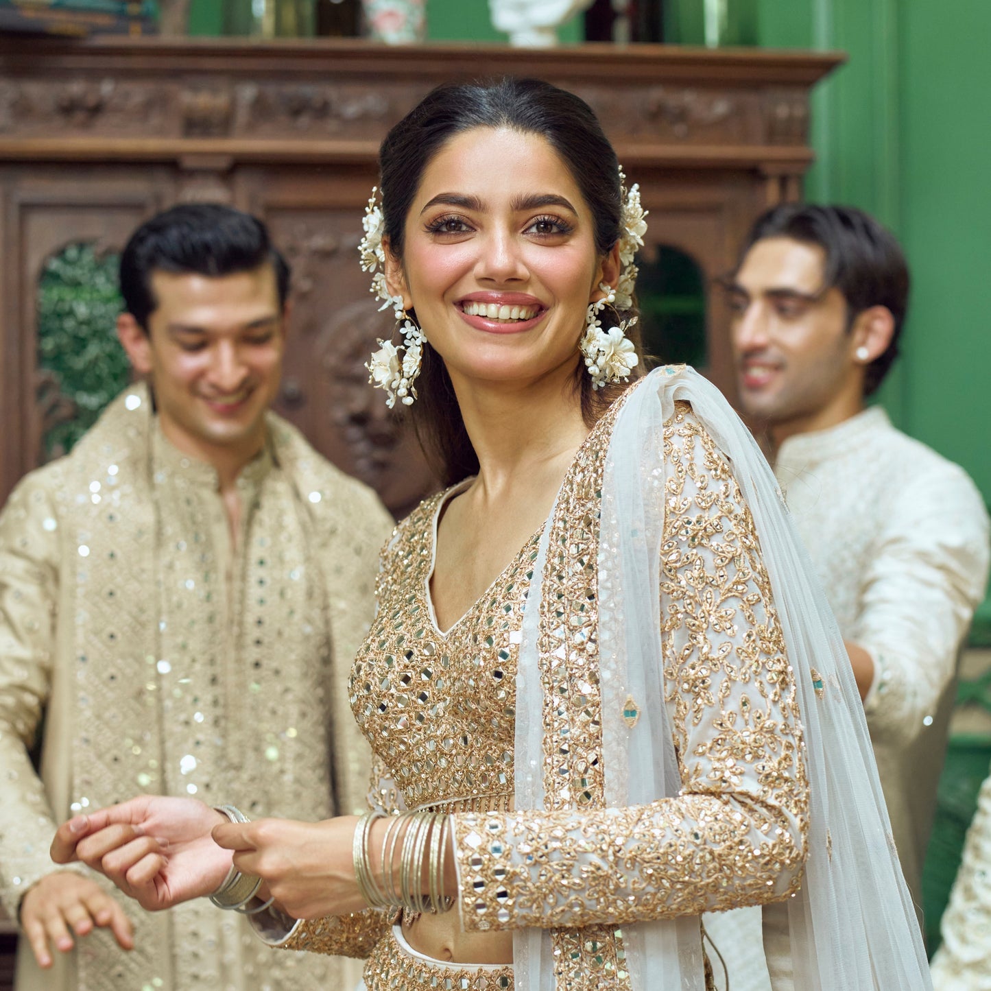 Amara handcrafted white resin floral statement earrings gold accents on model Abhinav Mishra collaboration bridal