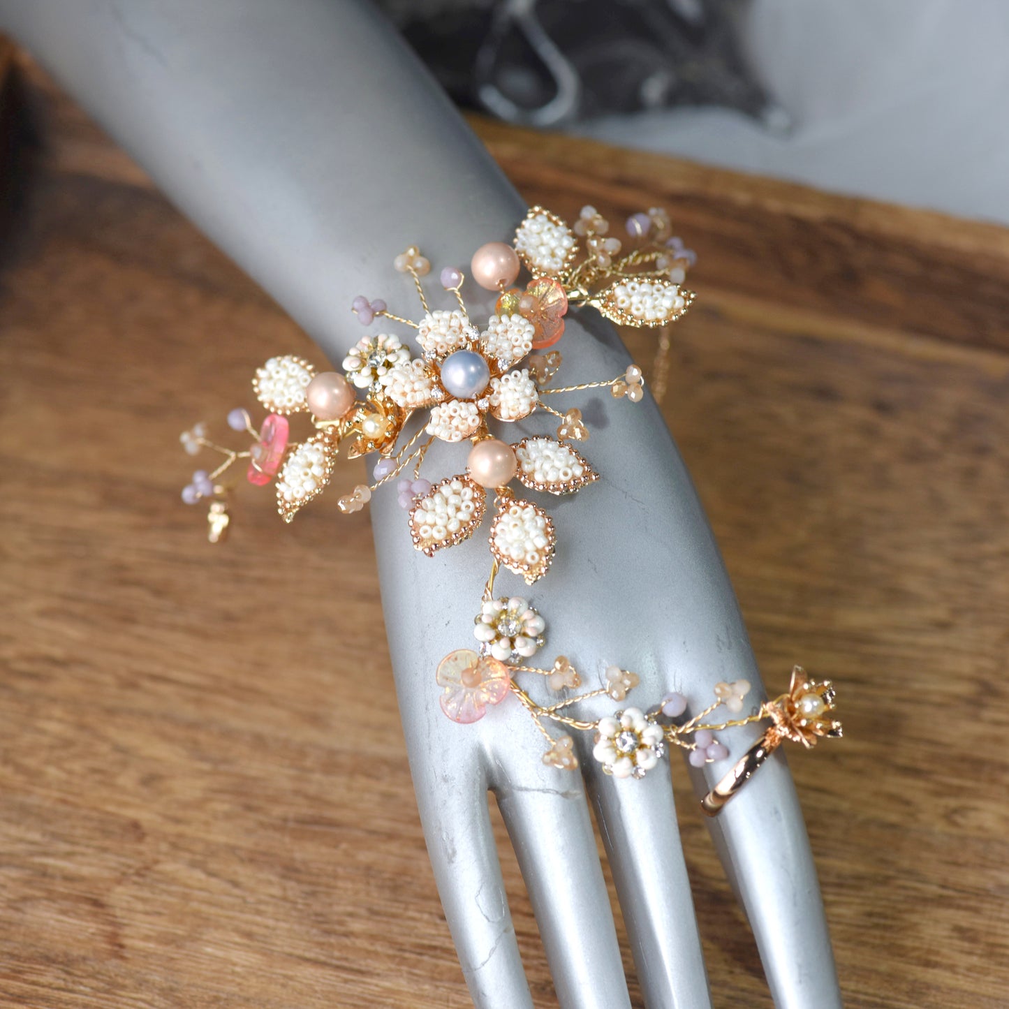 Model wearing Arabella handcrafted metal bead floral haath phool hand harness golden cream beige bridal