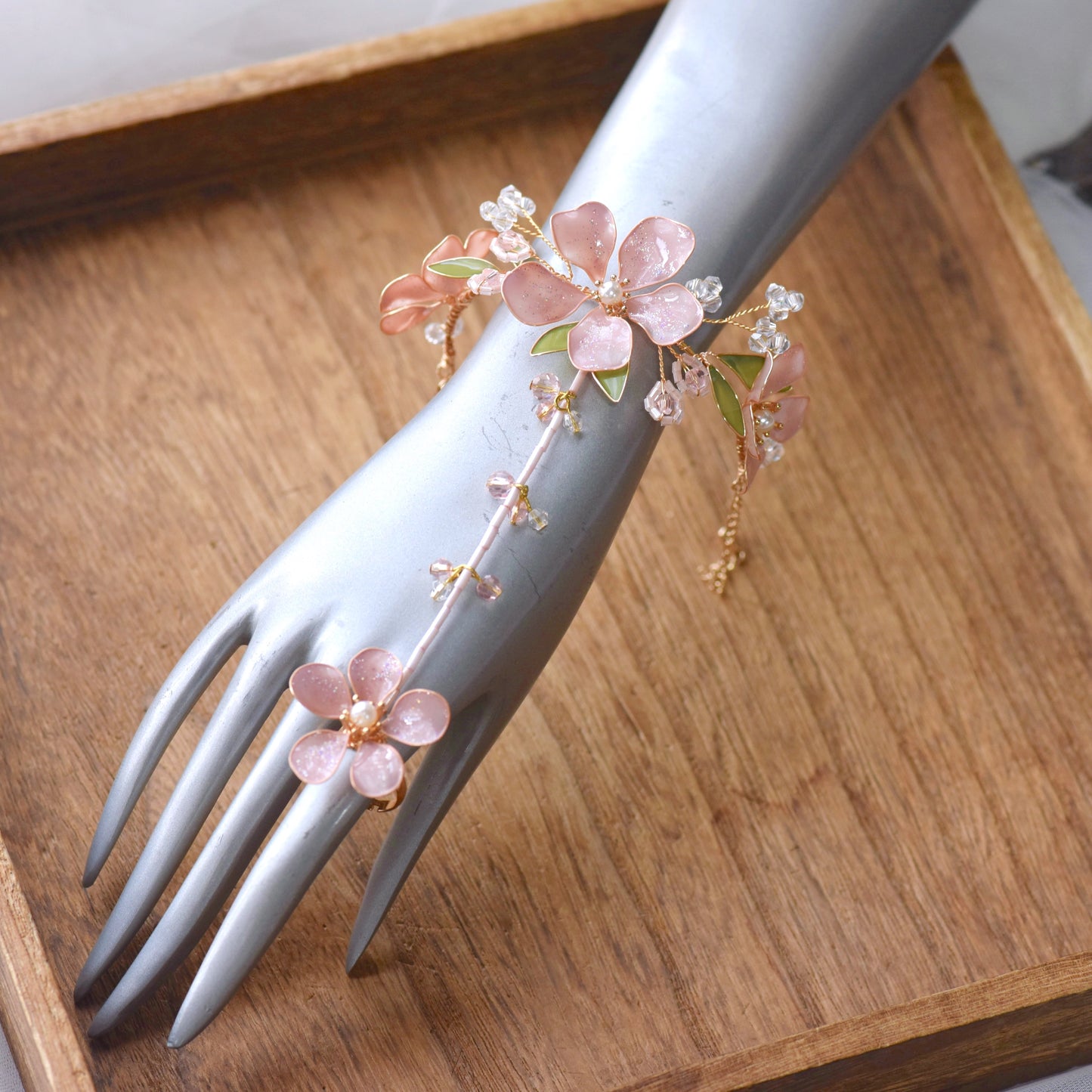 Aubri pink resin floral haath phool worn from wrist to finger on hand