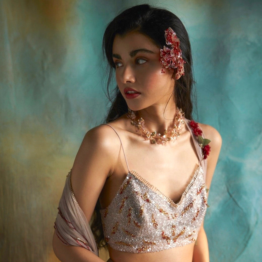 Model wearing Celestina handcrafted resin floral necklace pink gold with white outfit