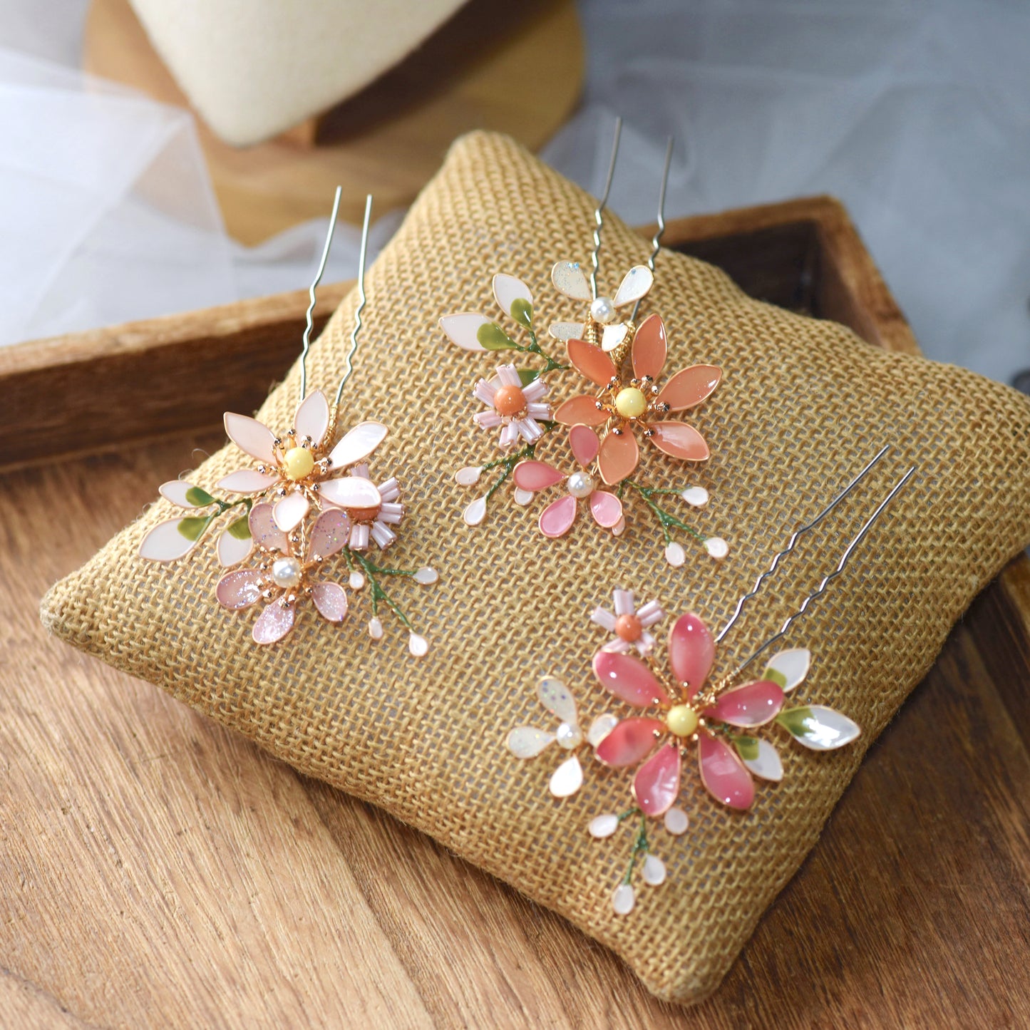 Close view of Chloe blush resin floral hair clips showing petal and pearl detail