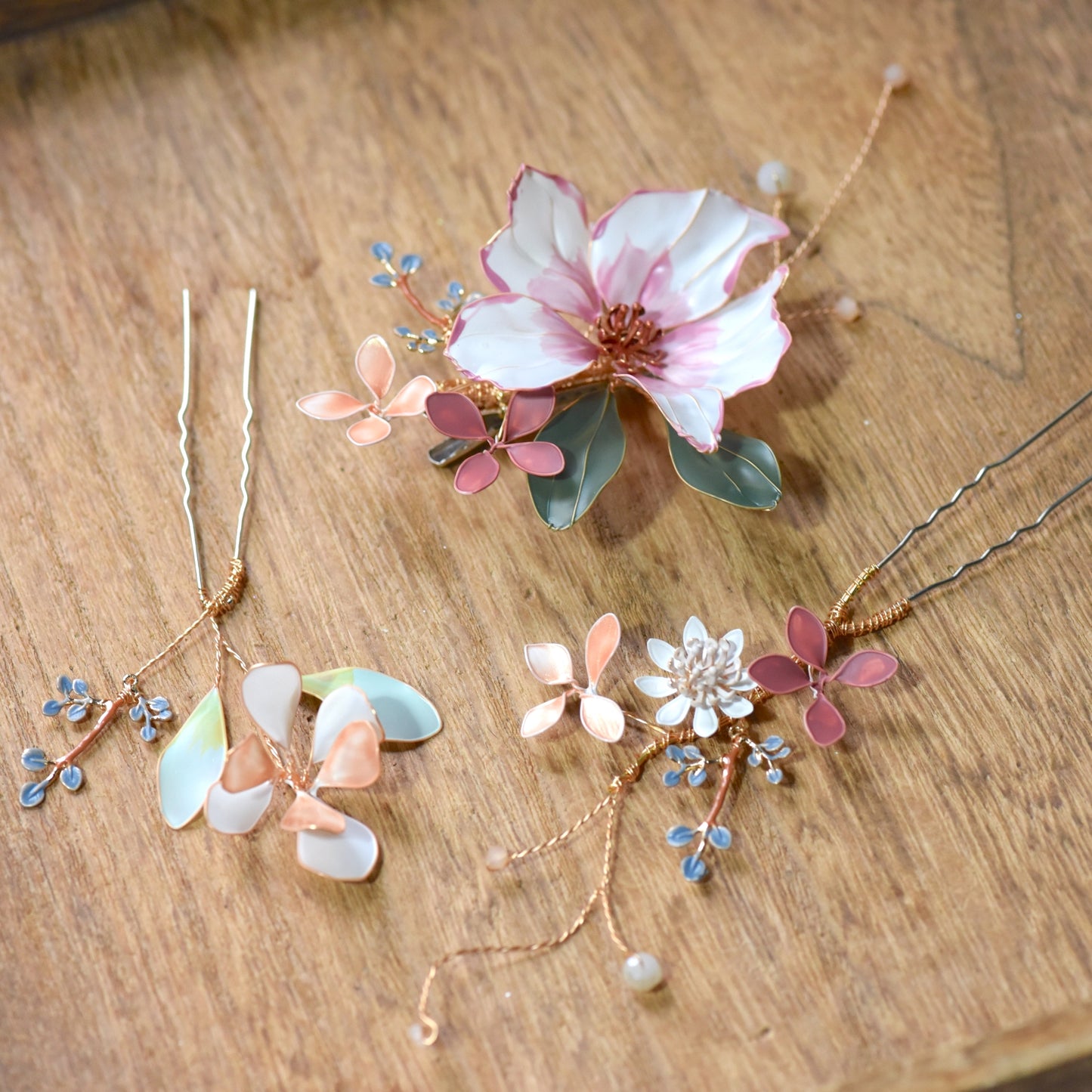 Side view of Esmeralda handcrafted floral hair accessory in blush pink and ivory resin petals with gold detailing