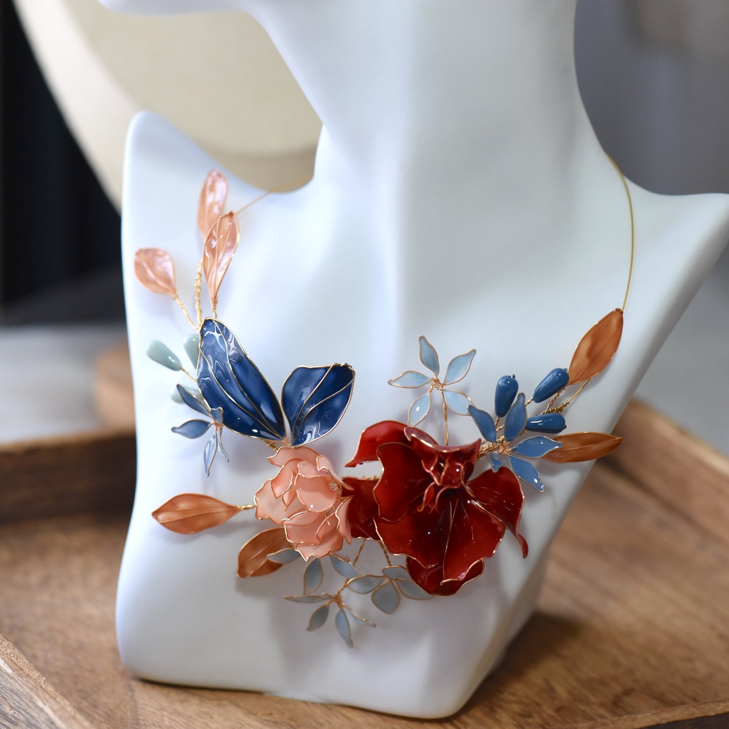 Close-up view of Nicola floral resin necklace showcasing layered petals, glossy resin finish and intricate gold wirework