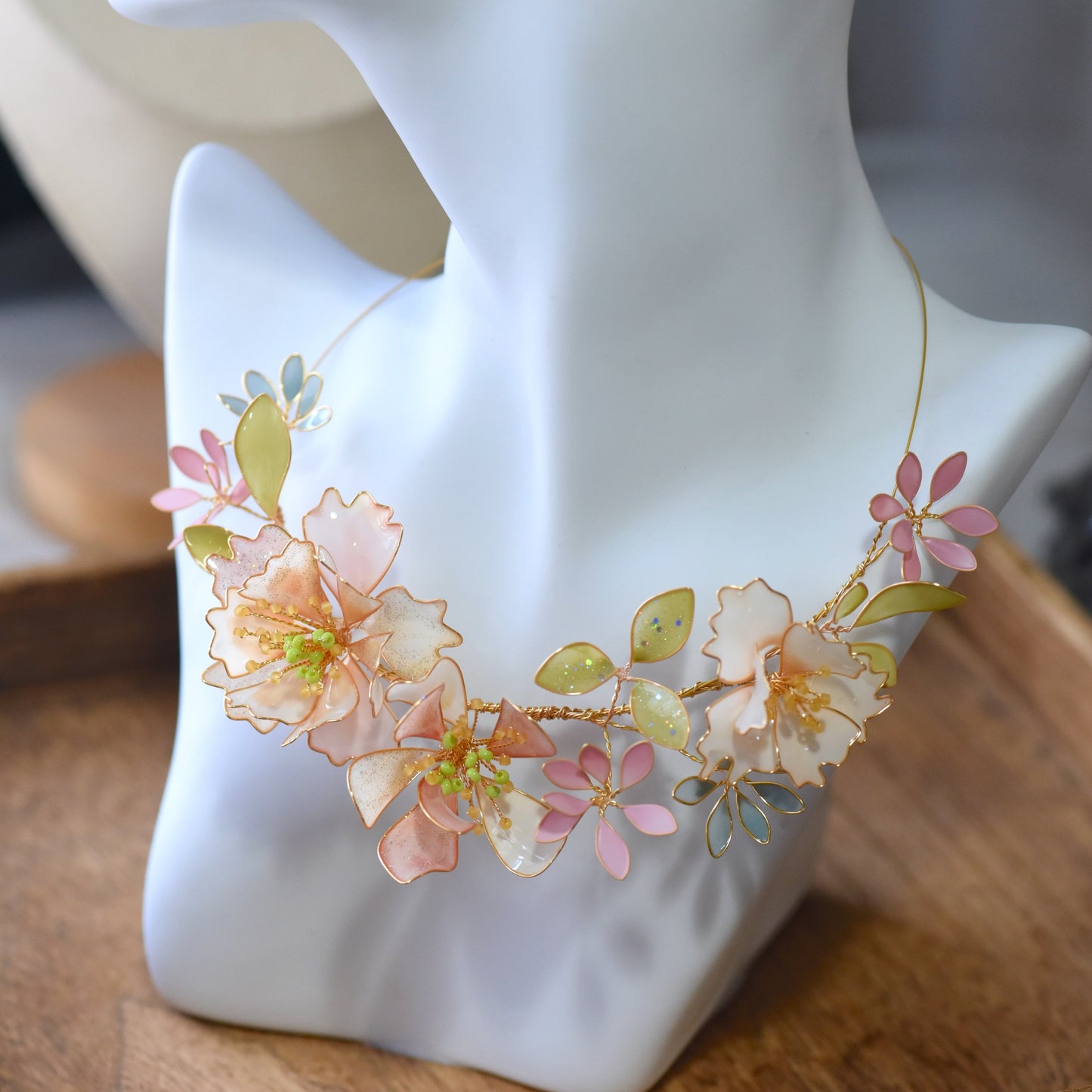 Side view of Sadie floral resin necklace showcasing pastel flower detailing, soft gold wirework and handcrafted design