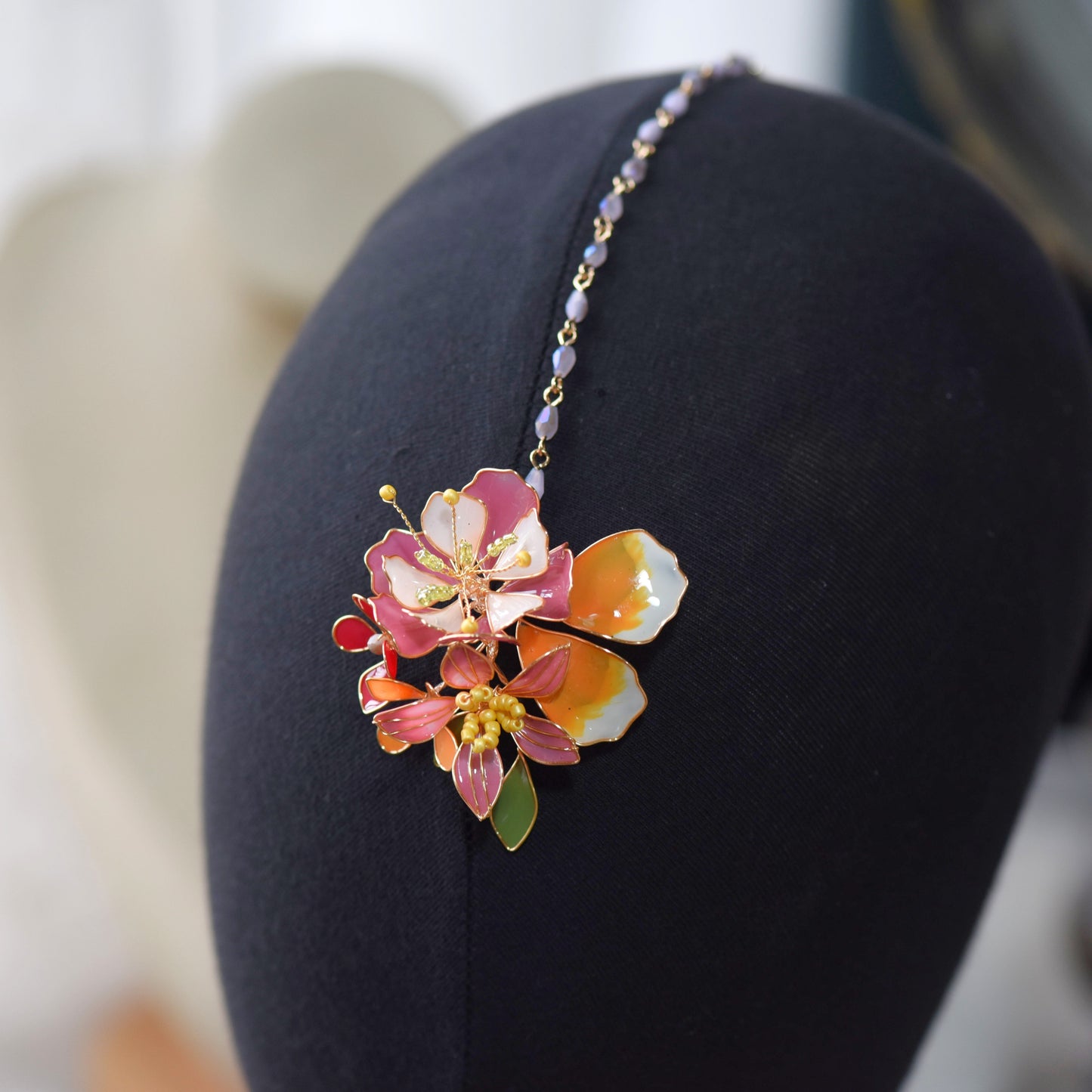 Model wearing Samara handcrafted resin floral maang tikka blushing pink orange gold bridal headpiece