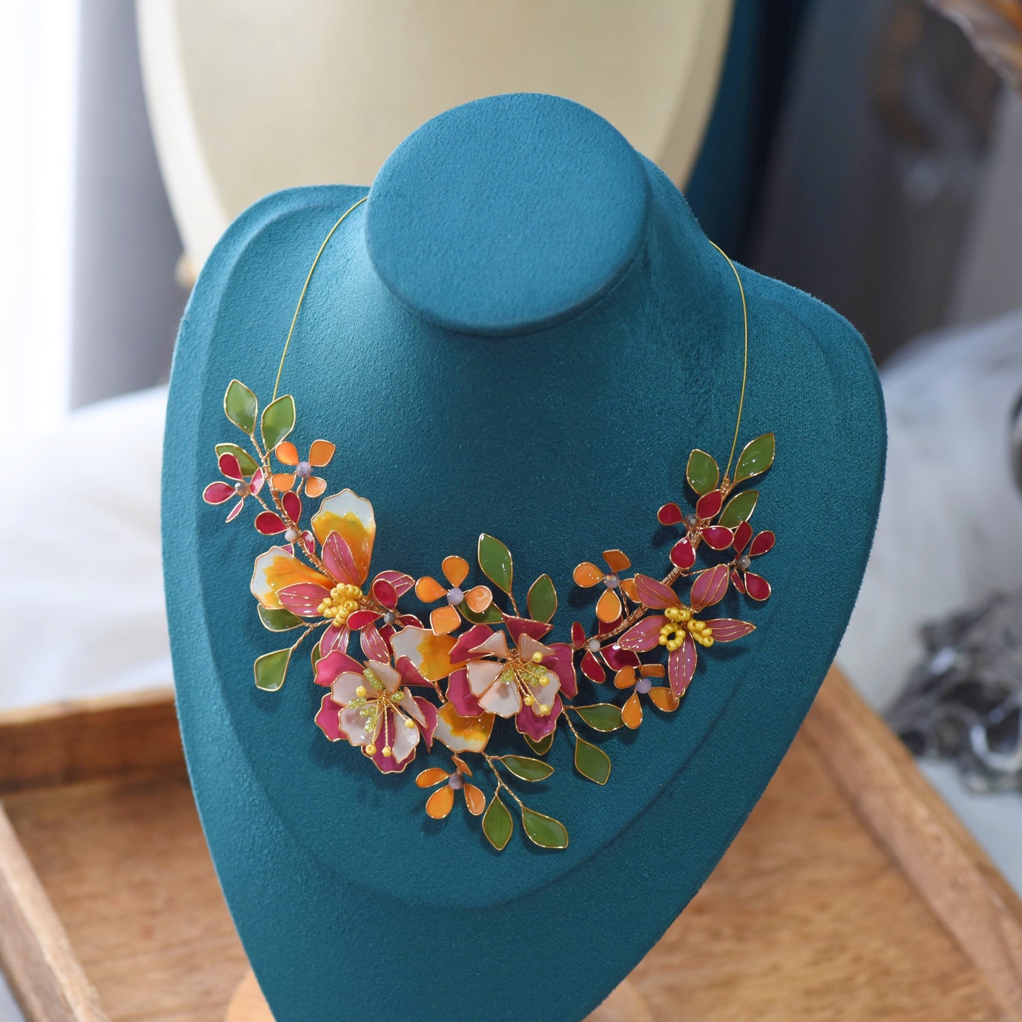 Samara handcrafted resin floral necklace vibrant pink orange green gold on bust botanical statement jewellery