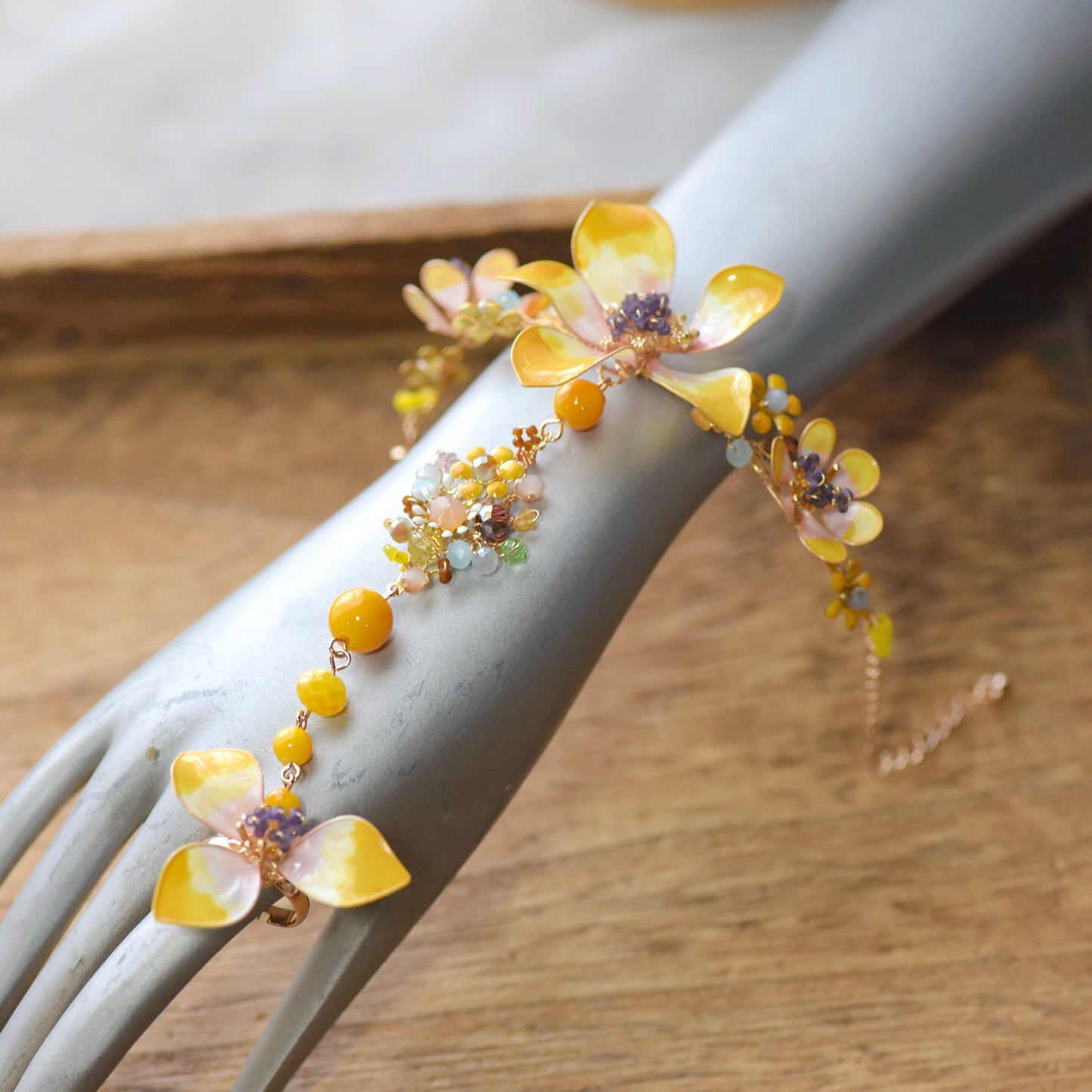 Model wearing Seraphina haath phool handcrafted resin floral hand harness yellow peach lavender violet bridal