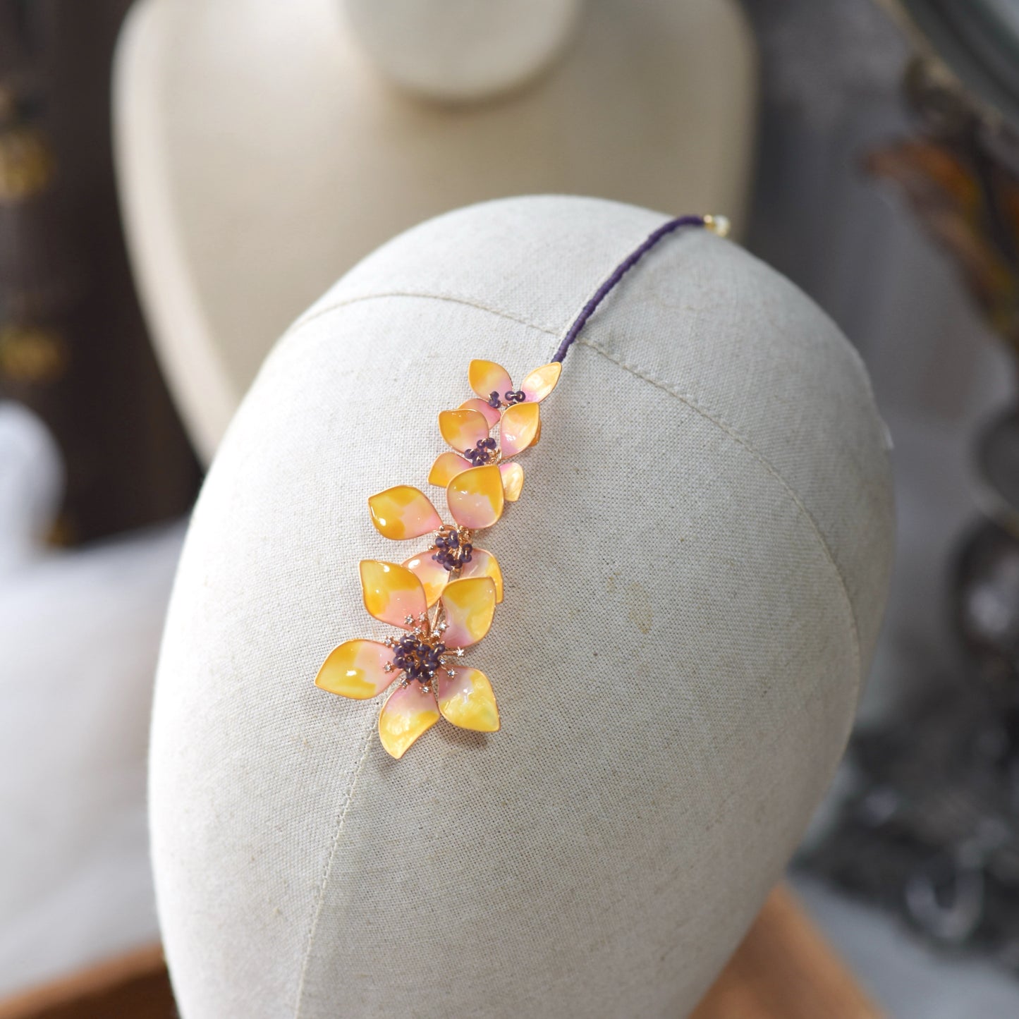 Model wearing Seraphina handcrafted resin floral maang tikka yellow peach gold violet bridal headpiece