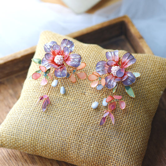Adelei purple and pink resin floral bridal jewellery set with earrings and necklace on jute cushion
