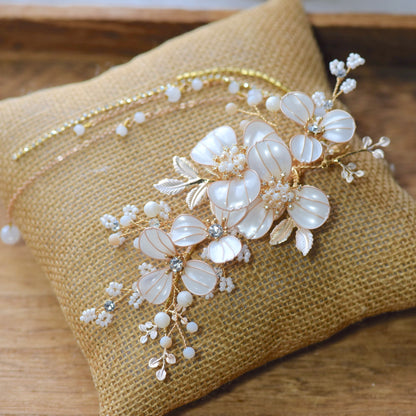 Adonia white resin floral bridal hair vine with pearl sprigs and gold leaves on jute cushion
