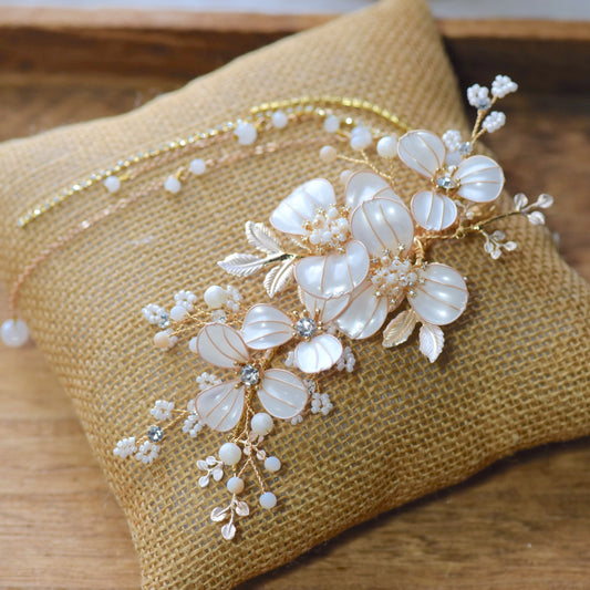 Adonia white resin floral bridal hair vine with pearl sprigs and gold leaves on jute cushion

