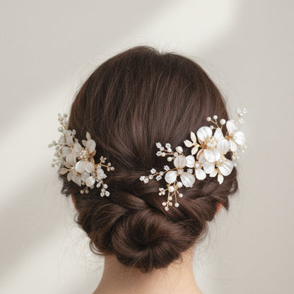 Model wearing Adonia white resin floral hair vine styled into a low bun
