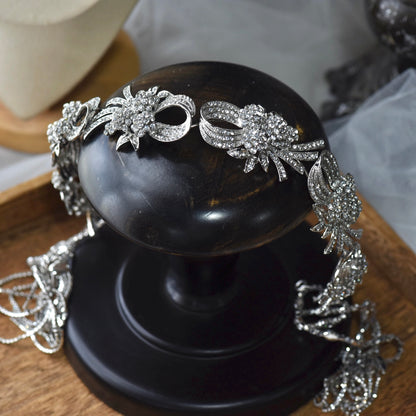 Alaia silver crystal and pearl floral bridal headband displayed on black stand
