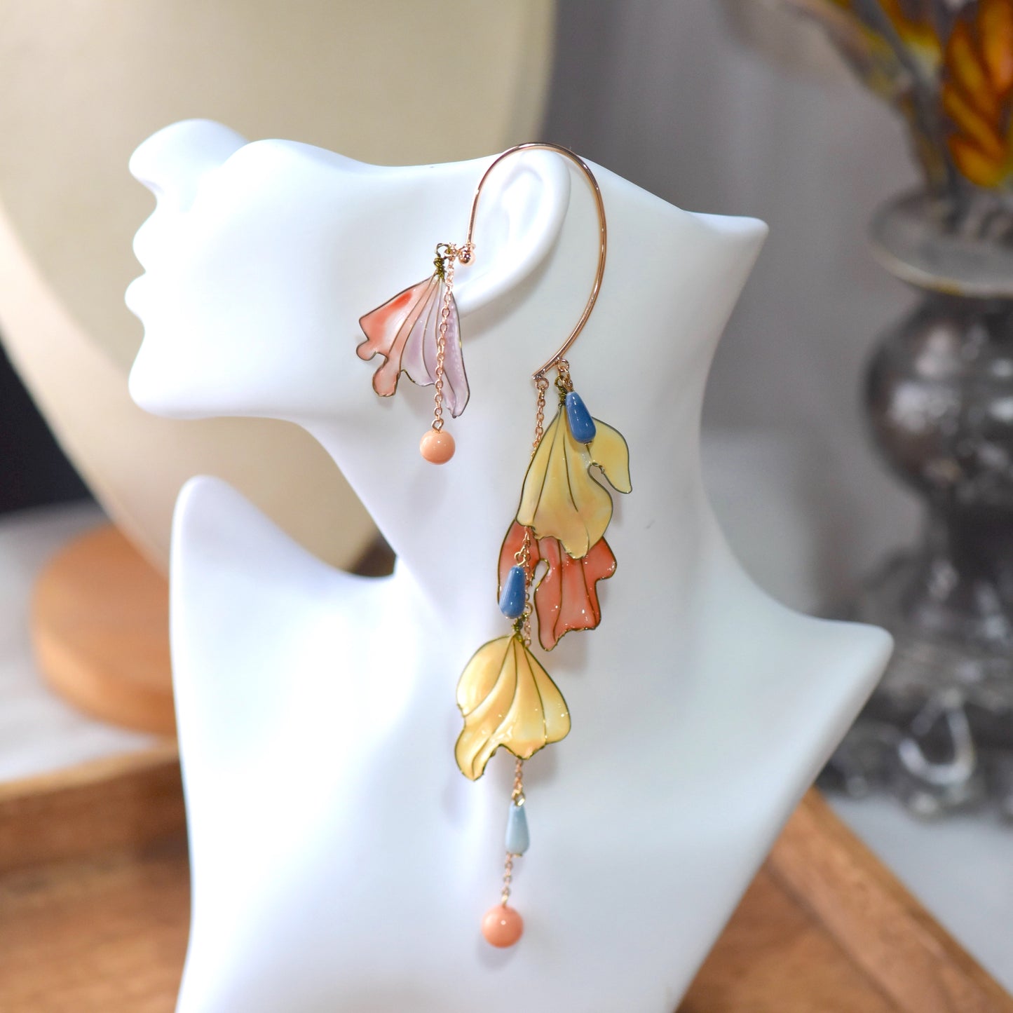 Side view of Alicia floral ear cuff showcasing layered resin petals, pastel bead drops and delicate gold wirework