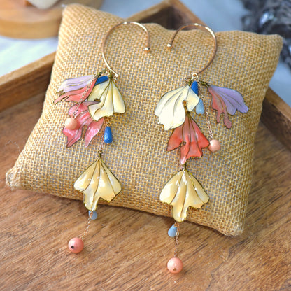 Alicia handcrafted floral resin ear cuff featuring cascading yellow, coral and blush petals with bead drops and gold detailing