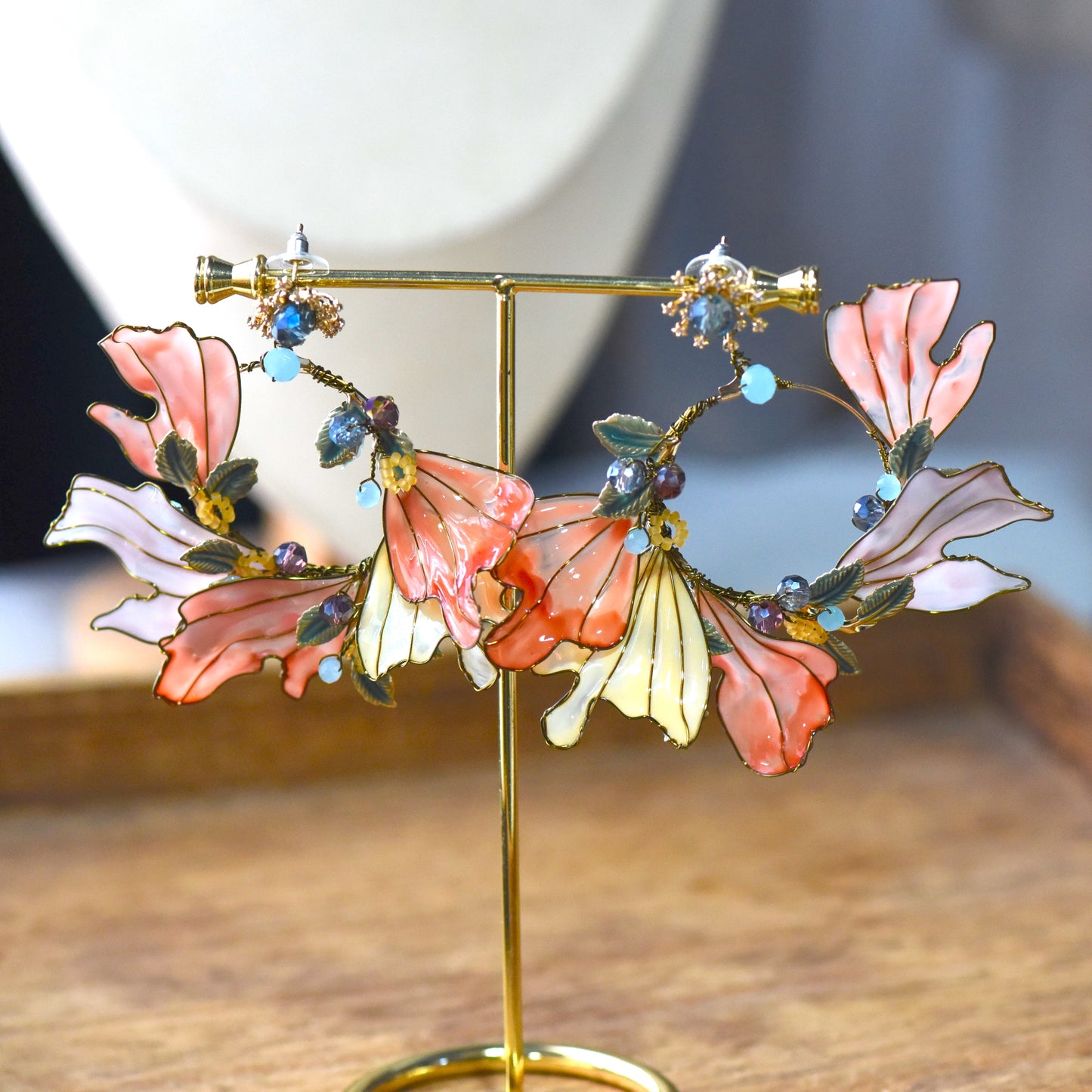 Close-up view of Alicia floral resin earrings showcasing layered petals, bead accents and intricate handcrafted gold wirework