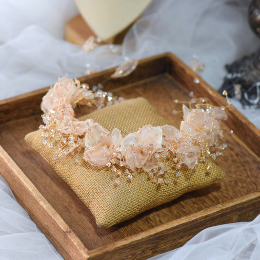 Alina peach resin floral bridal headband on jute cushion in wooden tray

