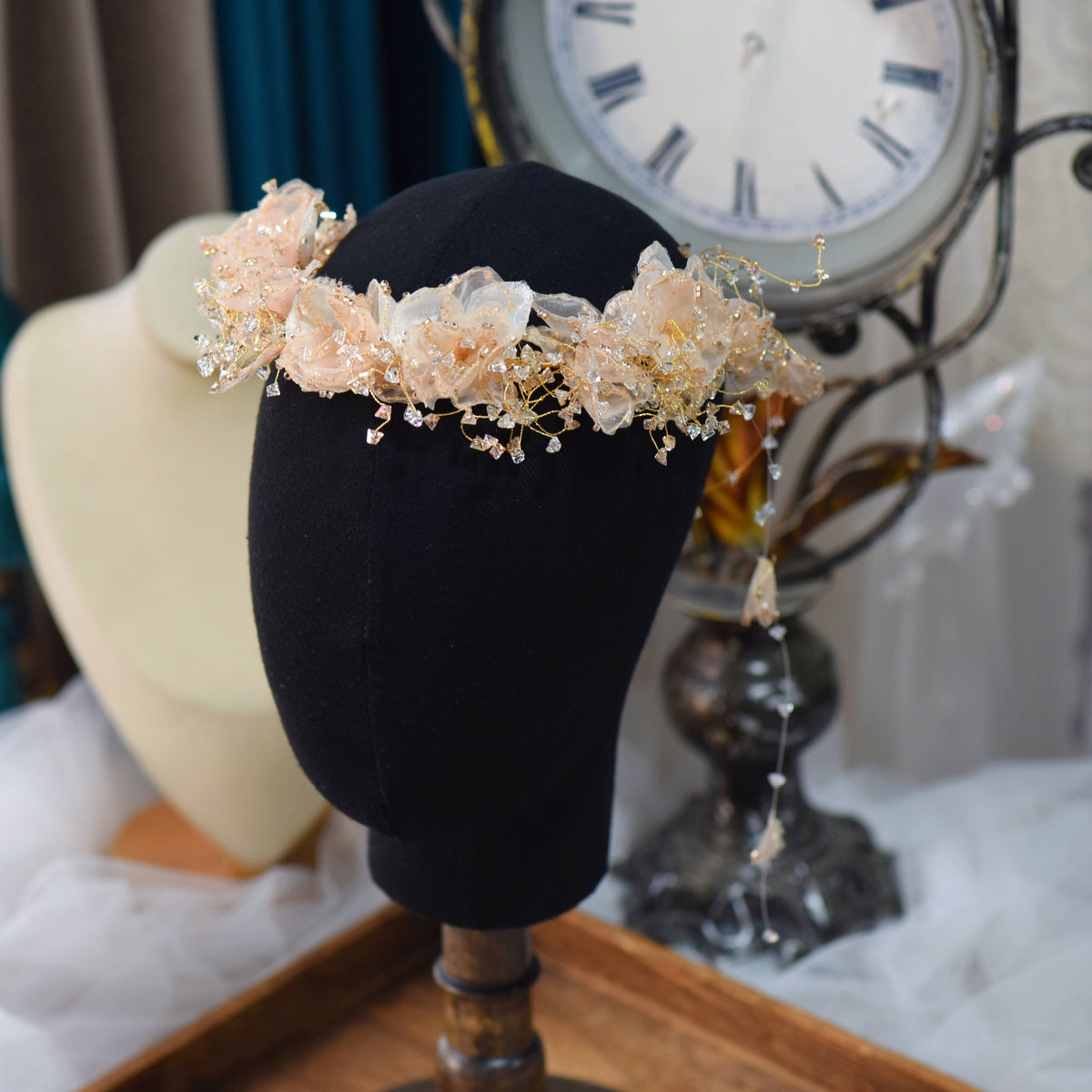 Alina peach resin floral headband displayed on black stand
