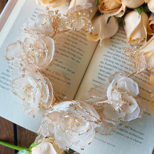 Amaira peach floral and bead bridal headband styled with roses and book
