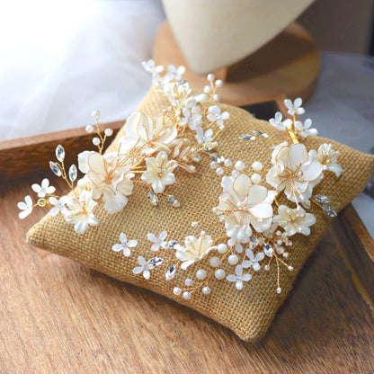 Amara handcrafted white resin floral bridal hair clips set of two gold accents flat lay burlap cushion
