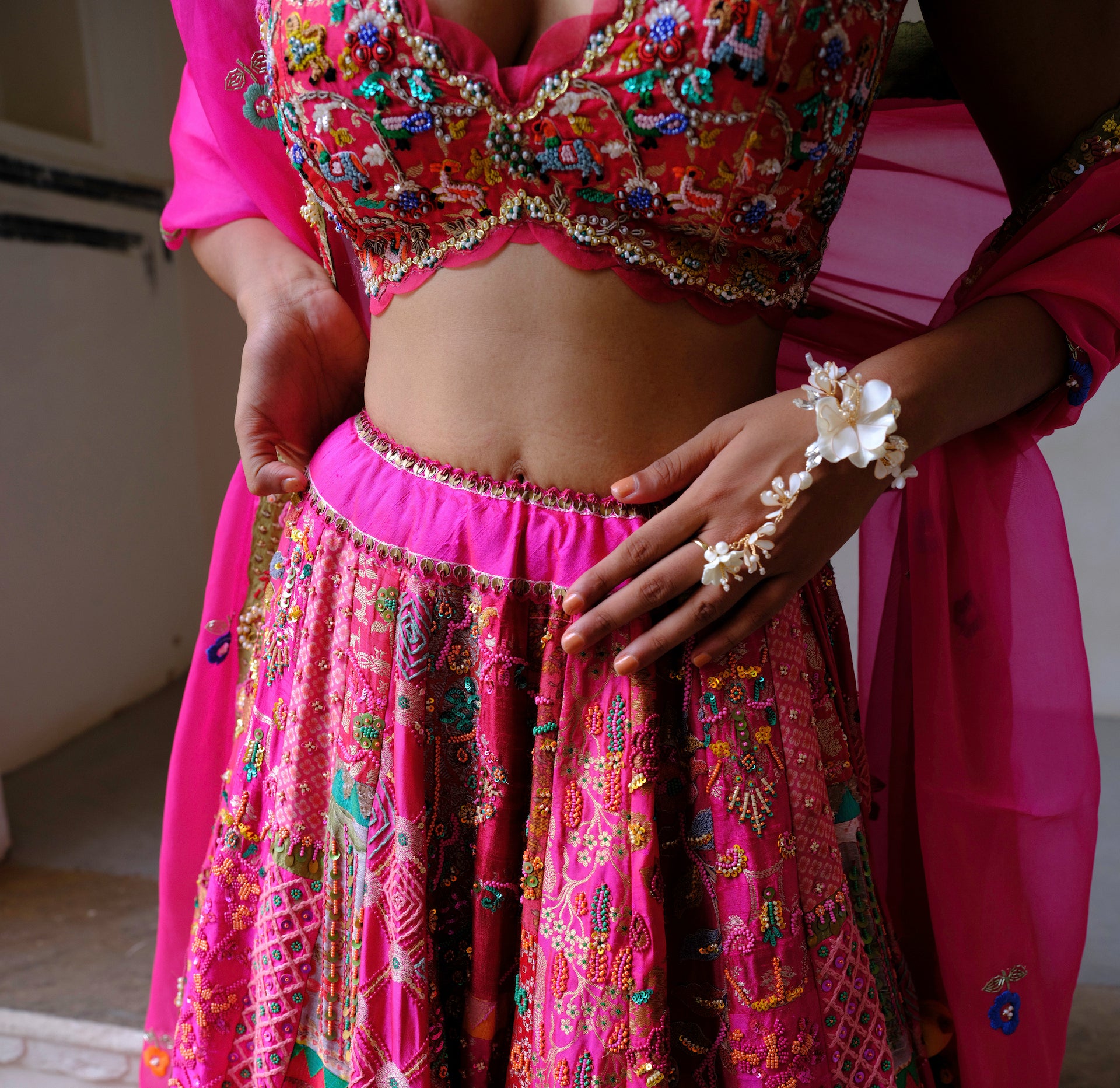 Model wearing Amara handcrafted white resin floral haath phool hand harness gold accents Aum & Asit collaboration
