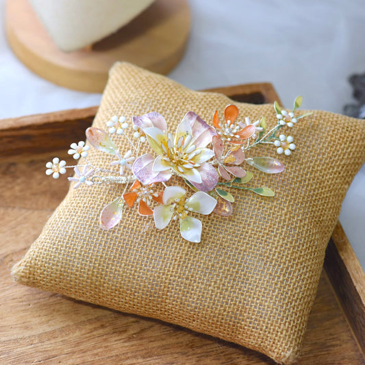Apricot Bloom apricot and pearl resin floral bridal hair vine with green leaves on jute cushion
