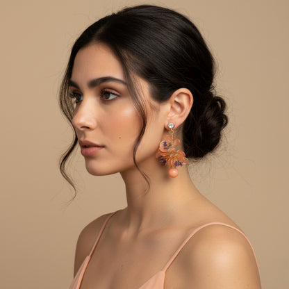Model wearing Apricot Fleur apricot-orange resin floral earrings

