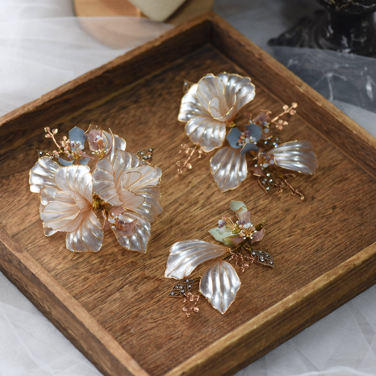 Close view of Arabella translucent resin floral hair pins showing glossy petals and fine wire detail
