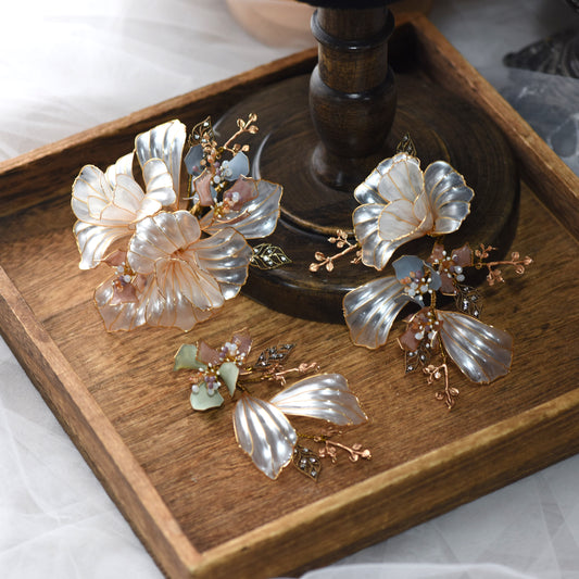 Arabella hair accessory set of three translucent resin floral hair pins displayed on a wooden tray

