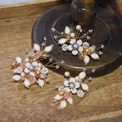 Arabella II handcrafted metal bead floral hair clips set golden cream blush pink pearl blue-grey on dark surface

