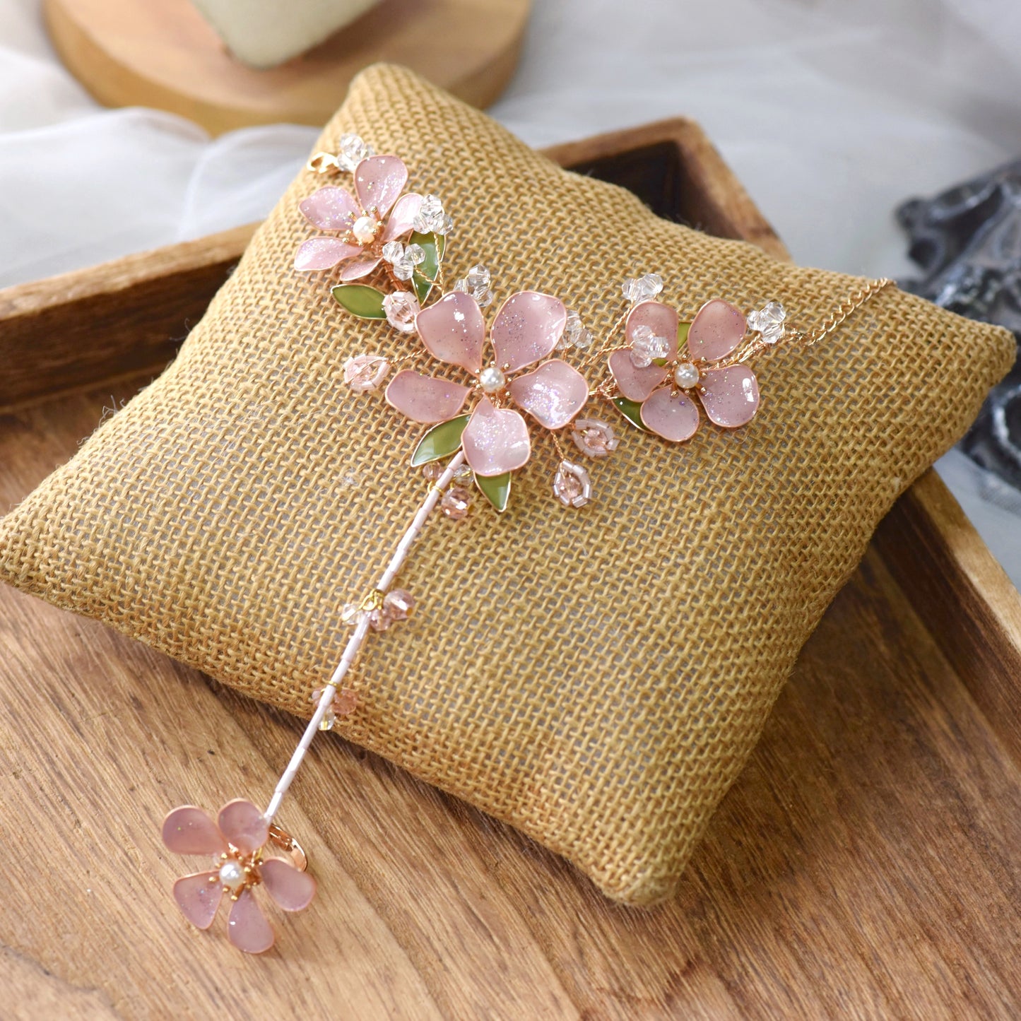 Aubri pink resin floral haath phool from bridal jewellery set on jute cushion