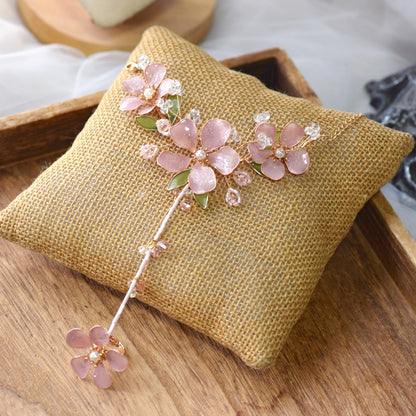 Aubri pink resin floral haath phool from bridal jewellery set on jute cushion