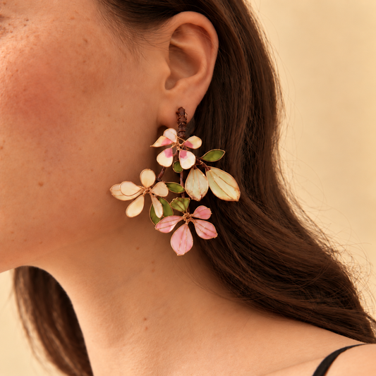Aveline blush pink and green resin floral branch earrings worn on the ear
