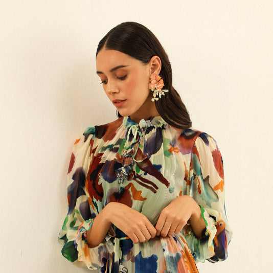 Ayaka peach and mint resin floral earrings worn with a green floral printed outfit
