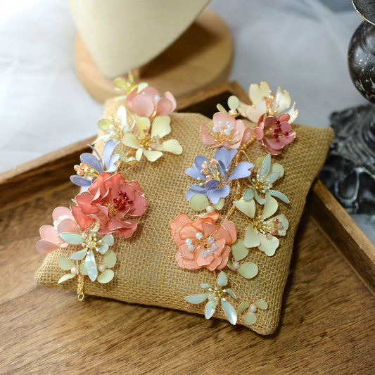 Ayaka peach blue and sage resin floral hair vines on an embroidered cushion
