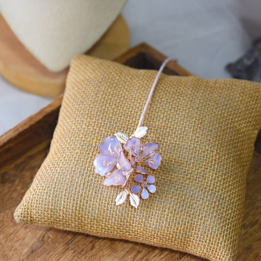 Belle lavender resin floral bridal maang tika in lilac on jute cushion
