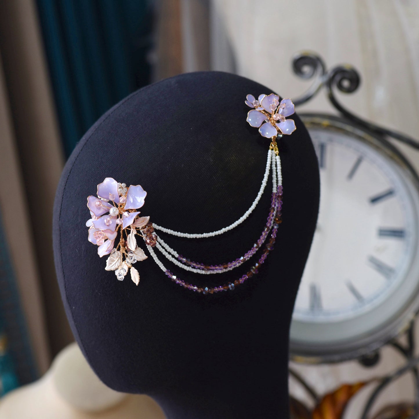 Belle lavender resin floral earrings with hair harness displayed on bust
