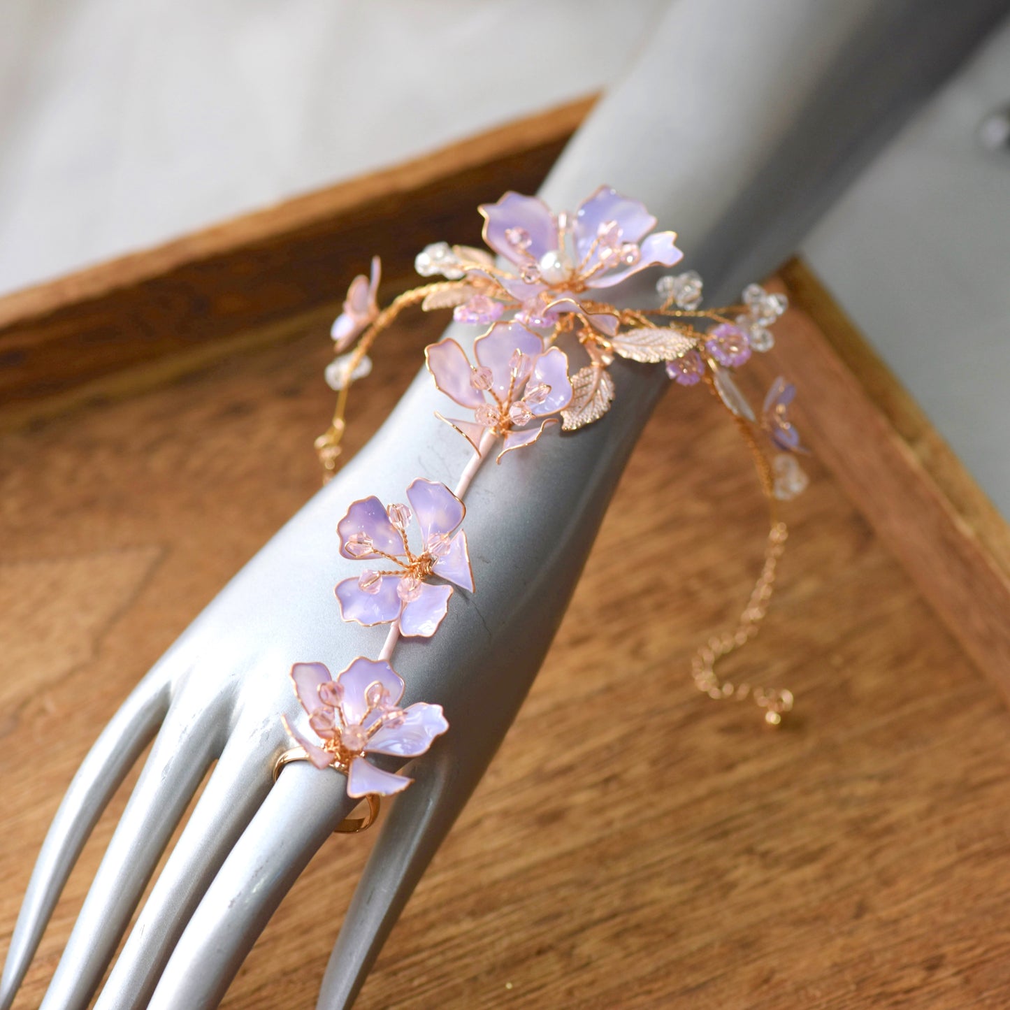 Belle lavender resin floral haath phool worn from wrist to finger on hand
