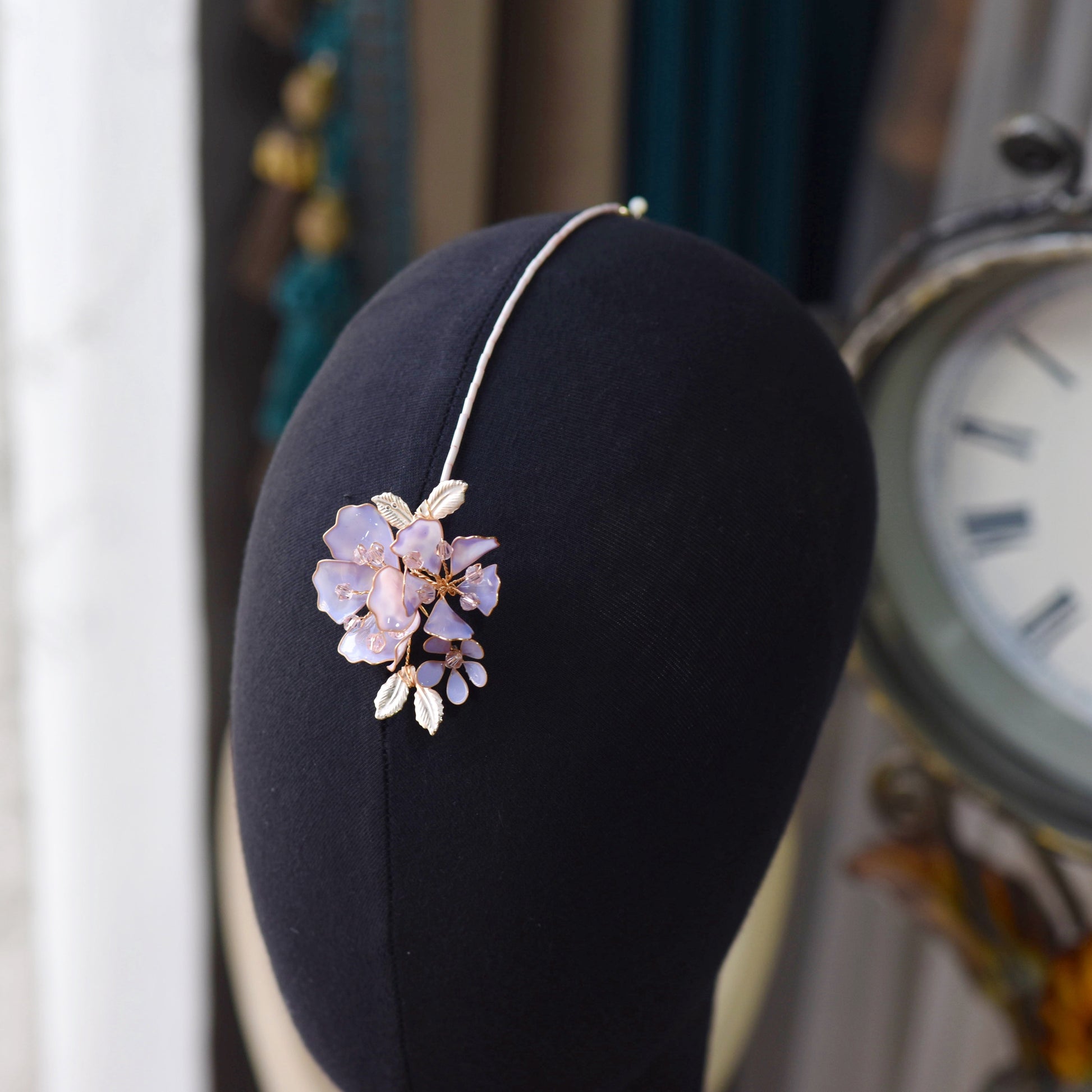 Belle lavender resin floral maang tika displayed on stand
