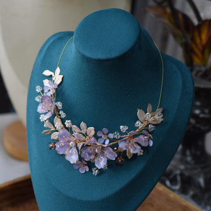 Belle lavender resin floral statement necklace displayed on blue bust
