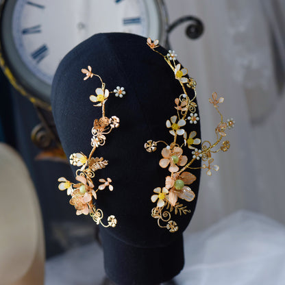 Betty yellow beige and gold resin floral hair vine set of two on a black display stand
