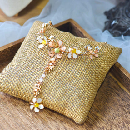 Betty yellow and gold resin floral haath phool hand harness on an embroidered cushion
