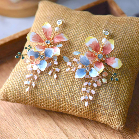 Bijou handcrafted pastel multicolour resin floral drop earrings blush pink yellow blue crystal centre bugle bead fringe flat lay burlap
