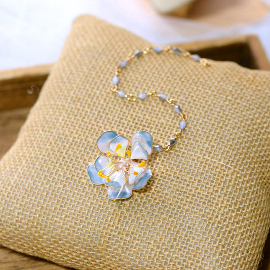 Bluesette handcrafted blue white gold resin floral maang tika bridal headpiece flat lay burlap cushion
