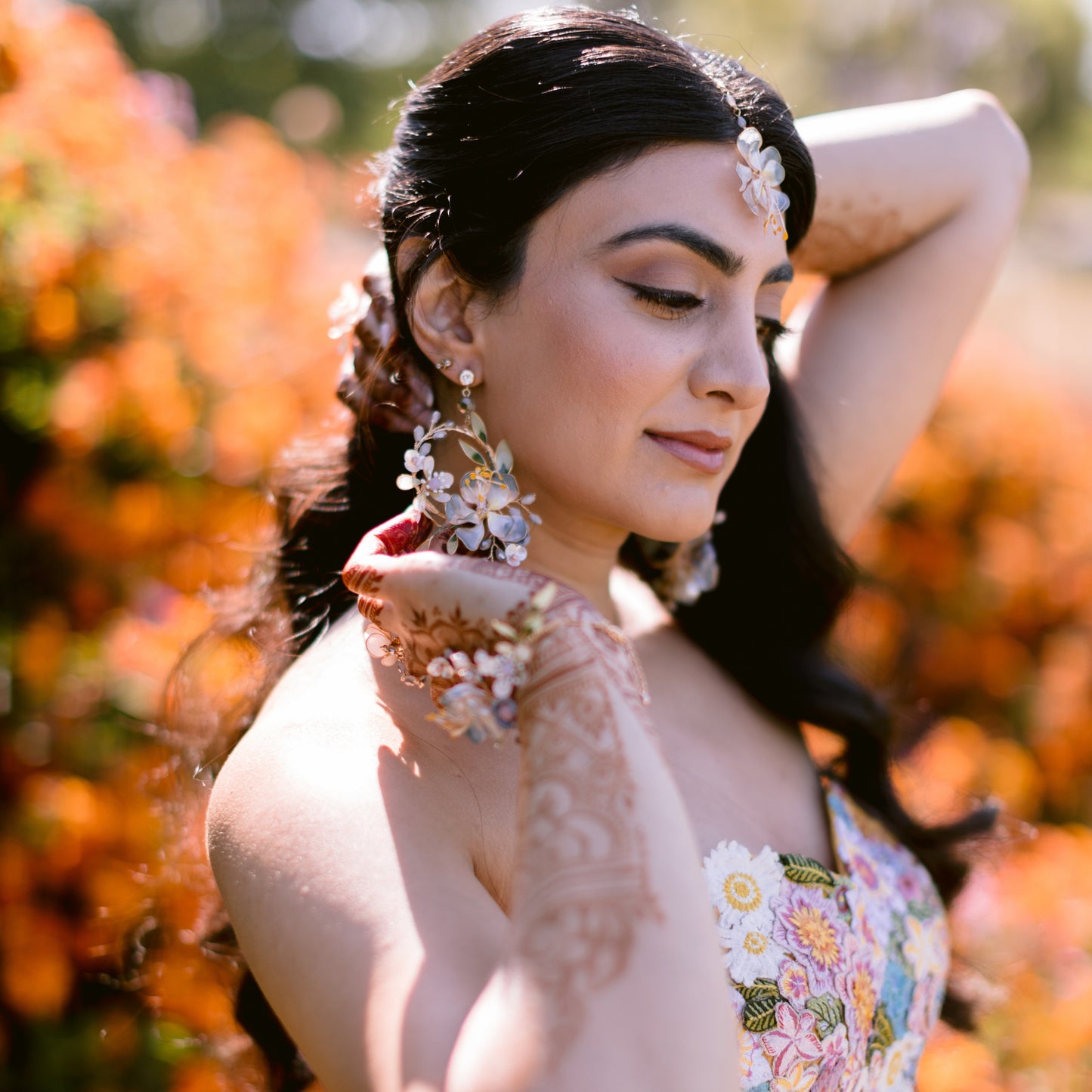 Bride wearing Bluesette handcrafted blue green resin floral drop earrings festive outdoor autumn flowers
