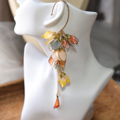 Brielle yellow and peach resin floral ear cuff shown worn on a white ear display
