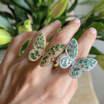 Butterfly Ring II zirconia butterfly ring in green and golden on hand, close up
