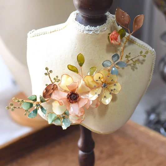 Calista handcrafted resin floral bridal hair accessory yellow peach blush pink blue green gold on white bust
